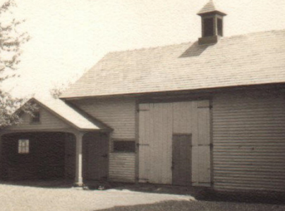 The green barn with small door.