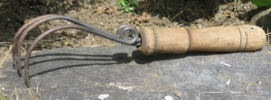 Garden claw tool used for weeding and roughing up the soil 
