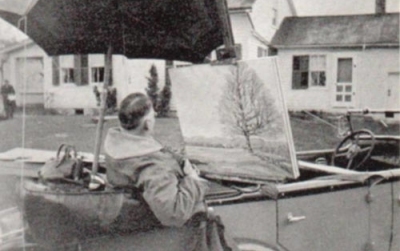 Robert Strong Woodward seated in the rear seat of his Nash Advanced Six, painting in 1933, before he owned the 8 cylinder 1936 Packard. The painting being made is The North Mowing. 
