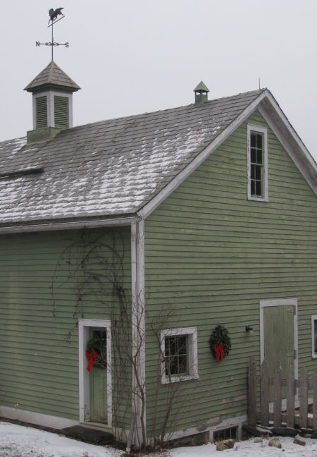 Door to barn grain room with Laurel Wreath. 